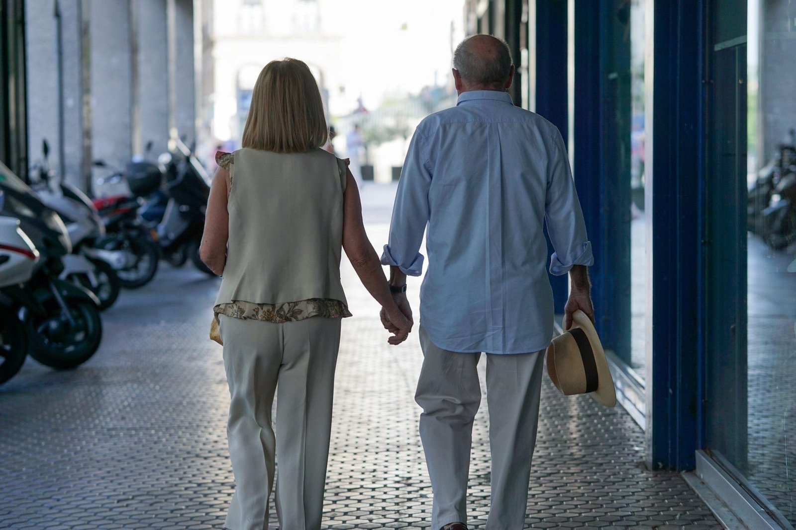 Older couple walking hand in hand